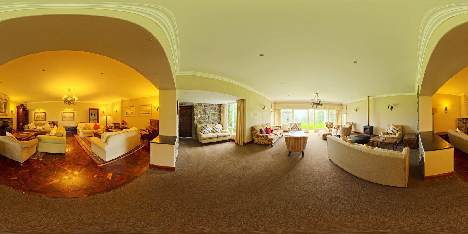 Wide equirectangular panorama showing the living room of a furnished home.